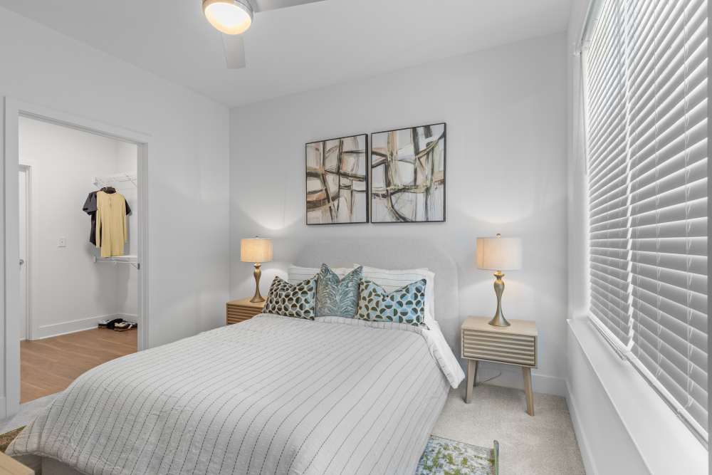 Cozy bedroom with stylish decor and natural light at Flats at College Park in College Park, Maryland.