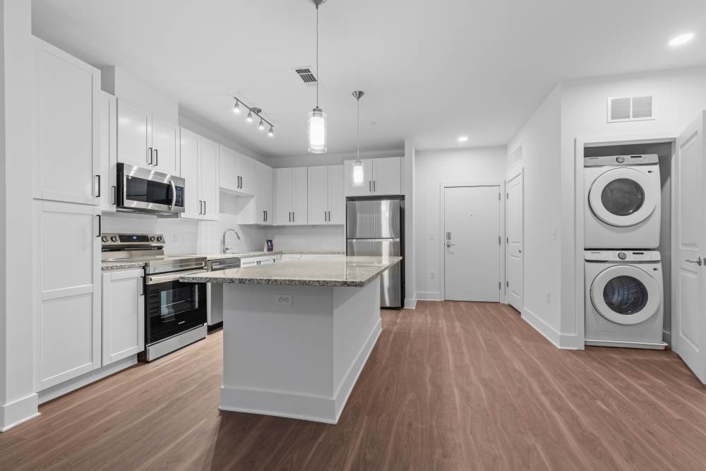 Kitchen with white cabinets and stainless appliances at Flats at College Park in College Park, Maryland.