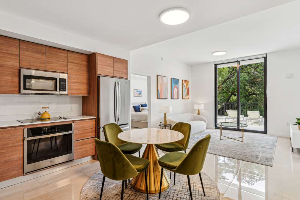 Apartment kitchen with stainless-steel appliances including refrigerator at Fifteen in Miami,Florida