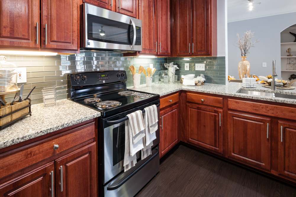 Apartment kitchen with wooden-cabinetry at Oaks at Sugarloaf in Lawrenceville,Georgia