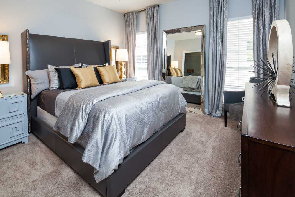 Bedroom with spacious bed at Oaks at Sugarloaf in Lawrenceville,Georgia