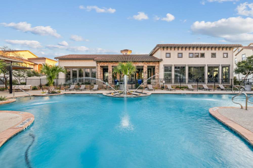 Sparkling water swimming pool with fountain at Costa Bella in San Antonio, Texas