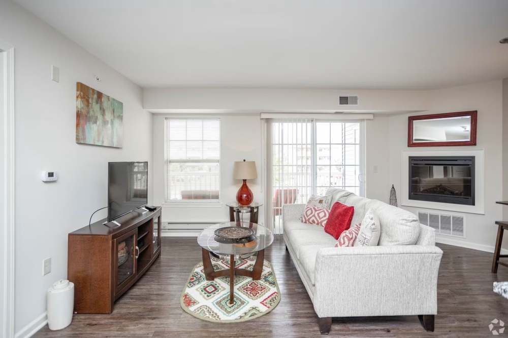 Living room with large windows at Fox Creek Estates in East Amherst, New York