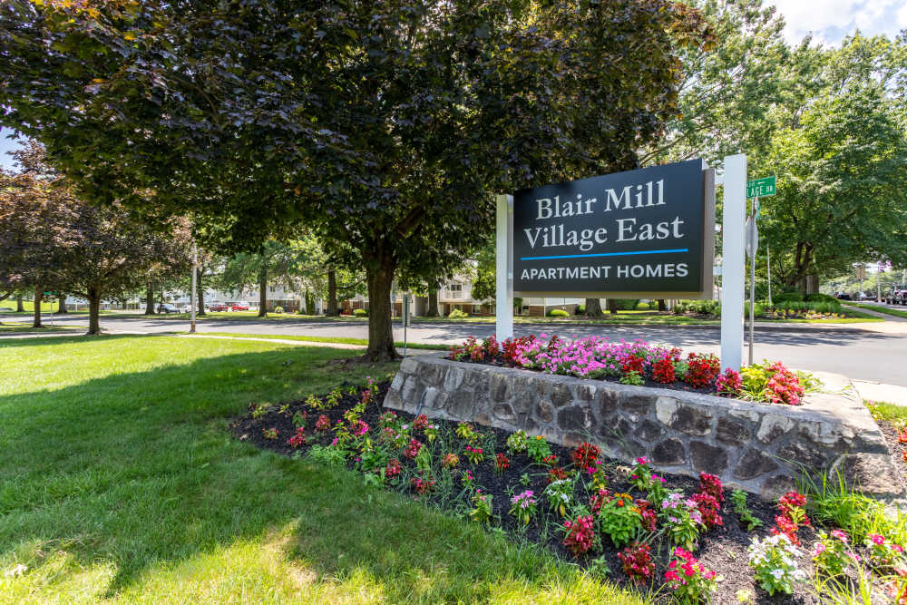 Monument sign surrounded by flowers at Blair Mill Village East Apartment Homes in Horsham, Pennsylvania