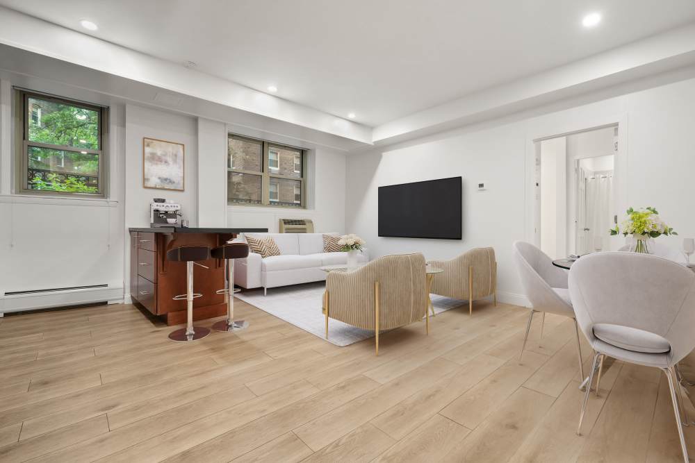 Living room with wood-style flooring at Camelot Court in Brighton, Massachusetts