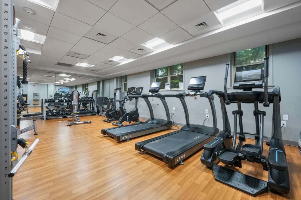 Fitness center with free-weights at Camelot Court in Brighton, Massachusetts