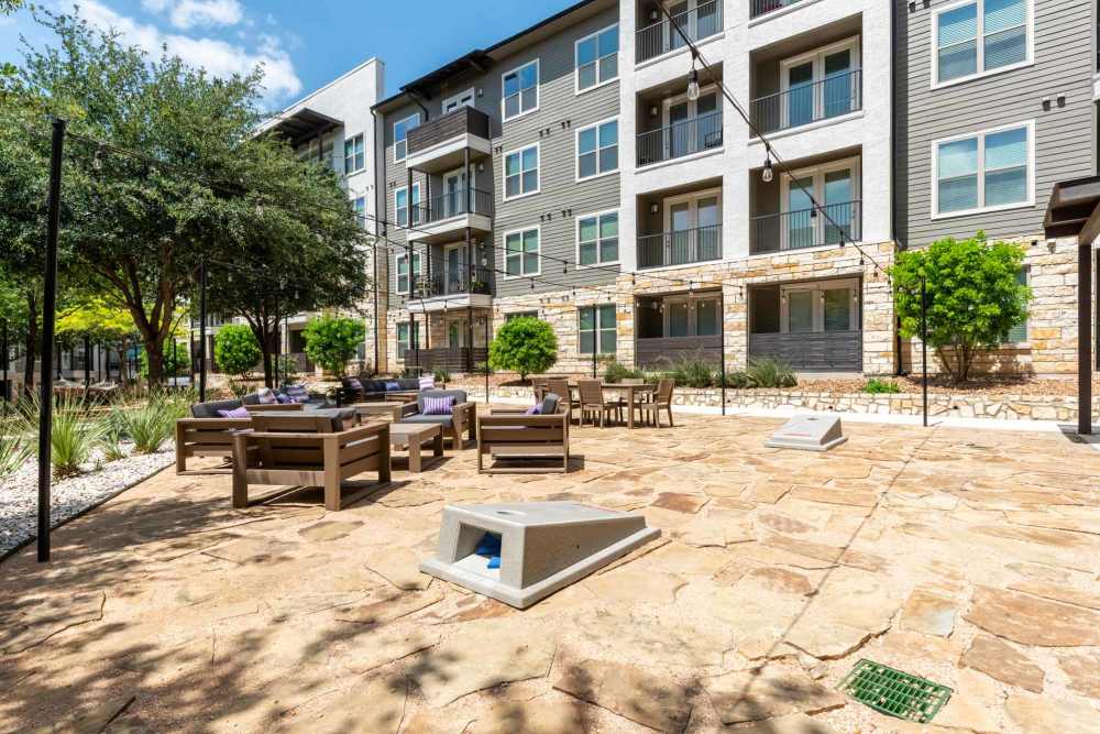 Courtyard at Henley at The Rim in San Antonio, Texas, featuring greenery and seating areas for residents.