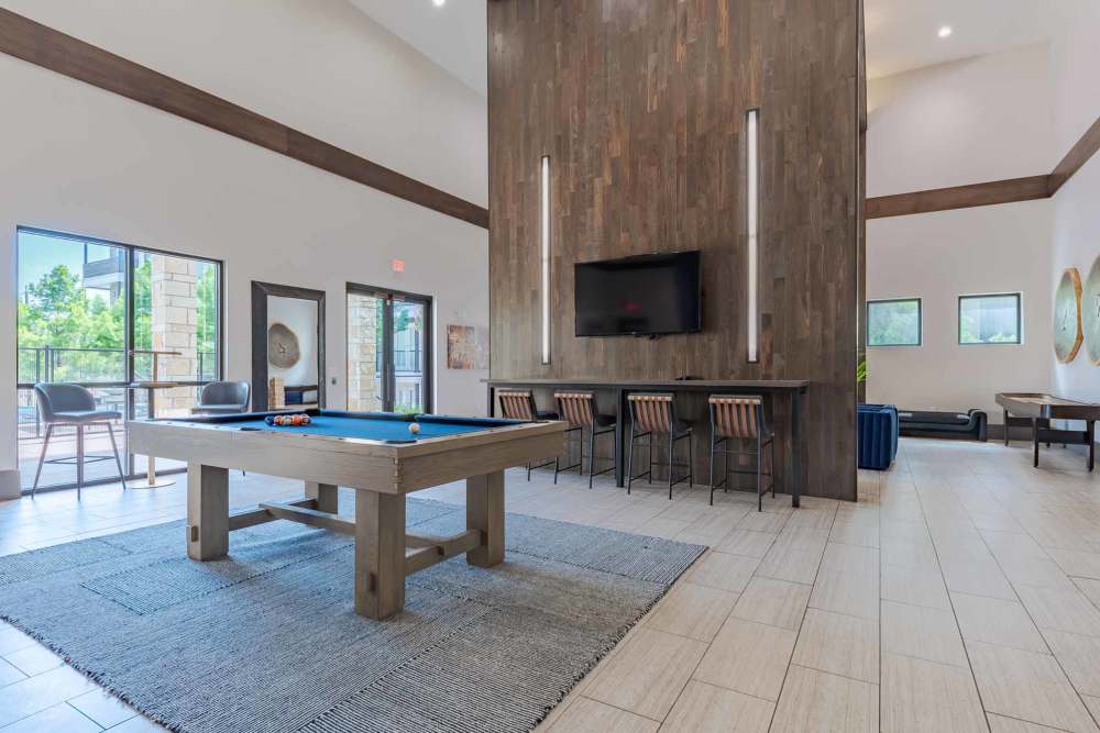 Pool table and bar area at Henley at The Rim in San Antonio, Texas, featuring a relaxed social atmosphere.