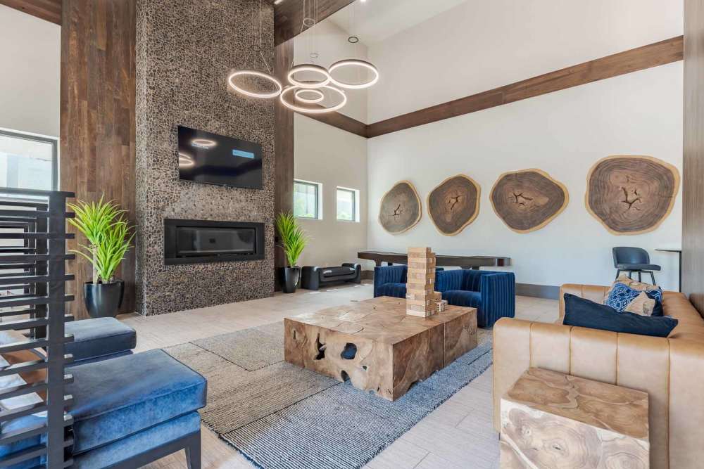 Living room at the Henley at The Rim in San Antonio, Texas, featuring modern furniture and large windows.