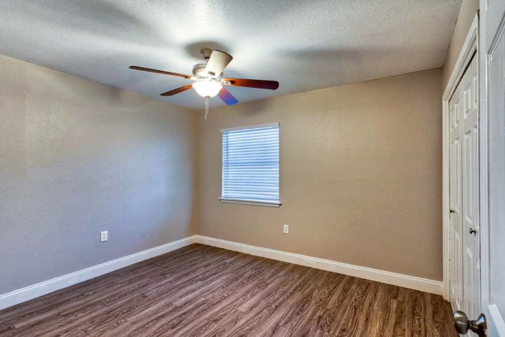 Spacious room with a ceiling fan at Troup Townhomes in Troup, Texas
