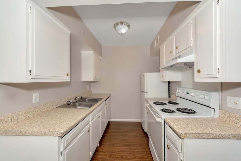 Kitchen with white appliances at Troup Townhomes in Troup, Texas