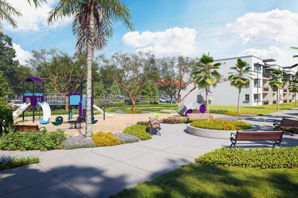 Inviting playground area with colorful play structures, surrounded by landscaped gardens and walking paths, providing a fun environment for children at The Renaissance in Naples, Florida.