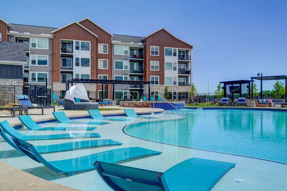 Resort-style swimming pool with sun loungers at Clear Creek Crossing in Wheat Ridge,Colorado
