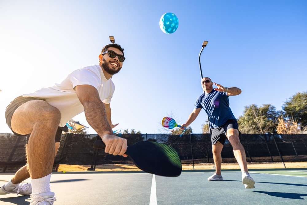 Residents playing tennis on outdoor court at Union at the Park in Denver, Colorado