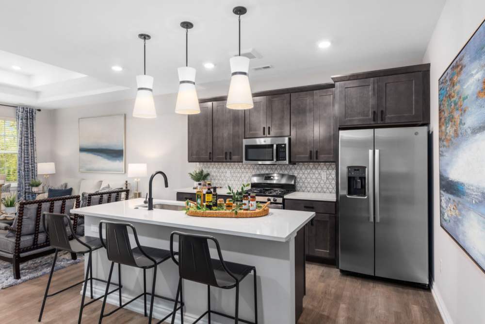 Modern kitchen with stainless-steel appliance at Encore at West Valley in White Lake, Michigan