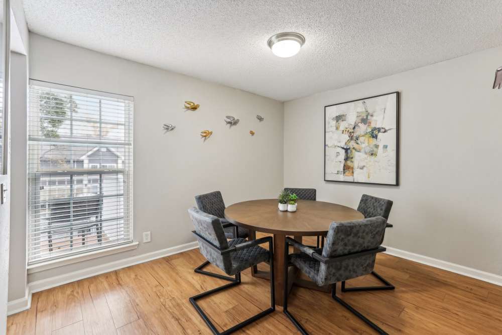 Dining room at 865 Bellevue Apartments in Nashville, Tennessee, featuring tables and chairs with a view of the surrounding greenery.