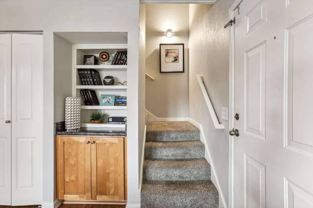 A hallway featuring a door and a bookcase at 865 Bellevue Apartments in Nashville, Tennessee.