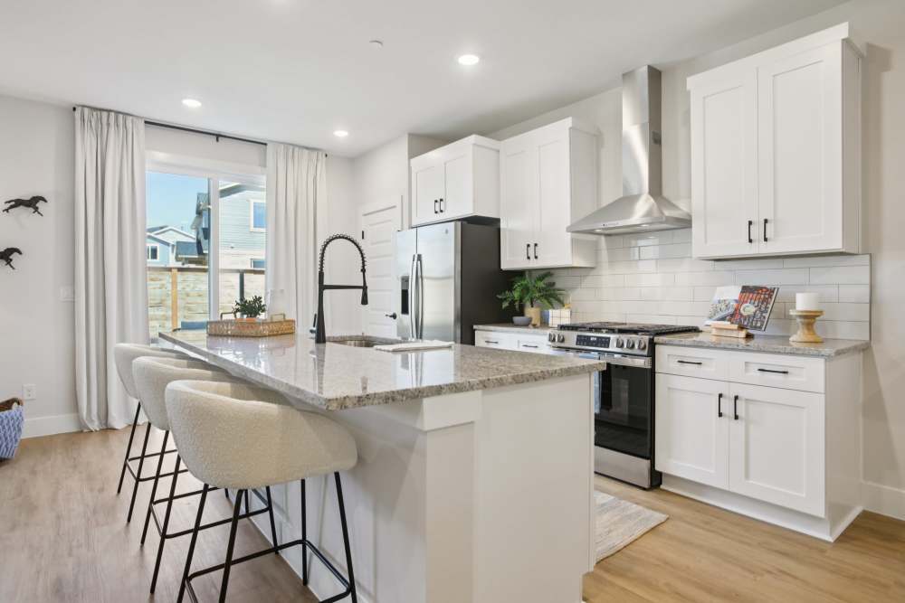Beautiful kitchen with counter tops Living room with a couch at BB Living Sweetwater Crossing in Bee Cave, Texas