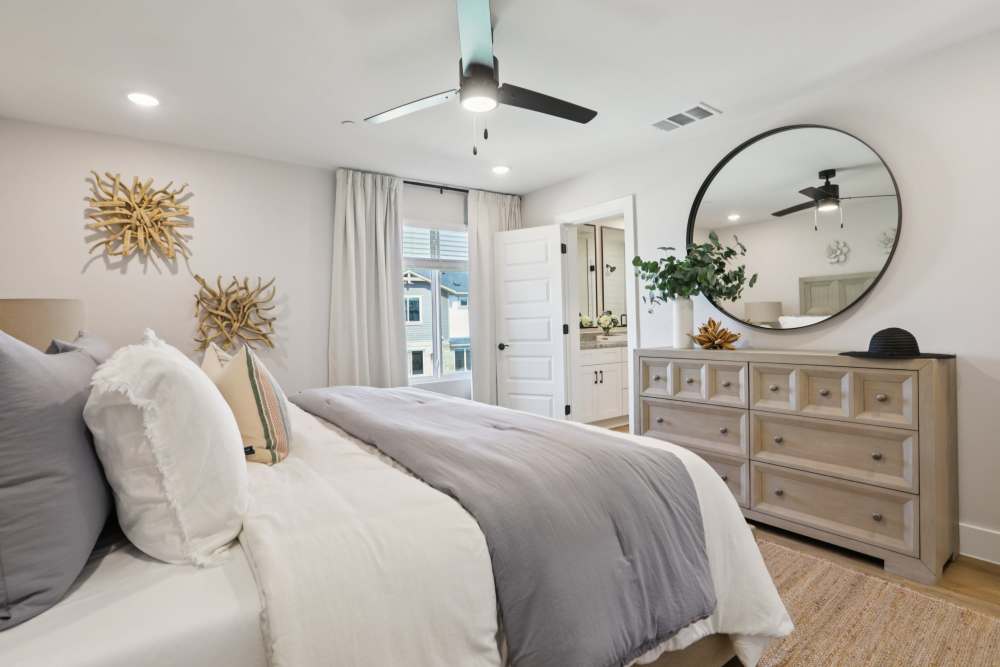 Elegant bedroom with big window Living room with a couch at BB Living Sweetwater Crossing in Bee Cave, Texas