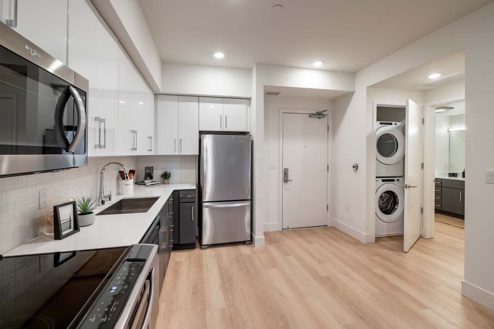 Kitchen with in-unit washer and dryer at The Dylan