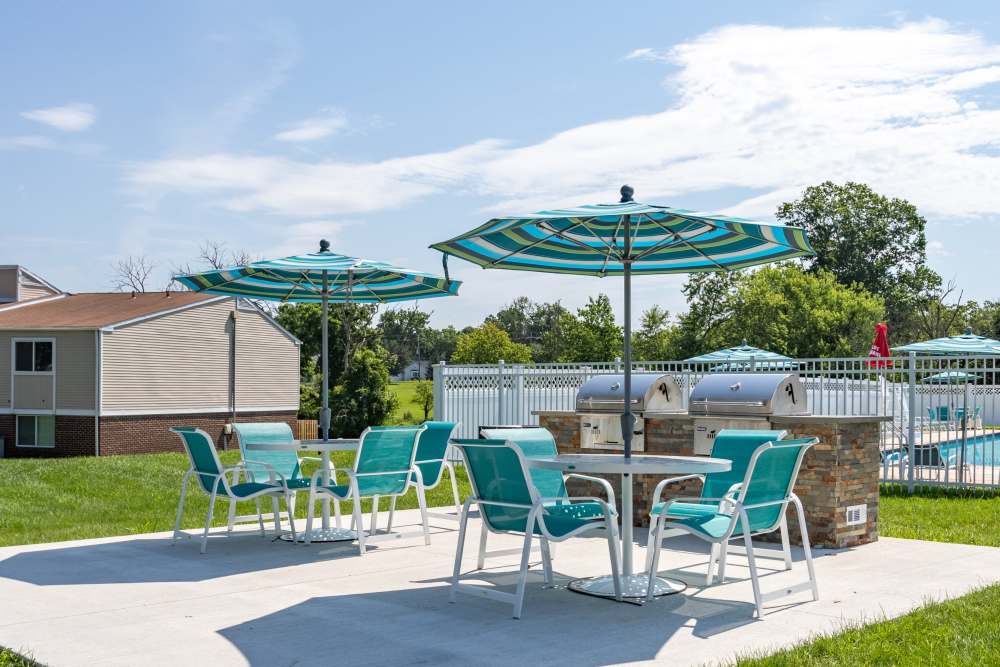 Playground with blue slides and nearby bench at Wissahickon Park Apartment Homes in Lansdale, Pennsylvania
