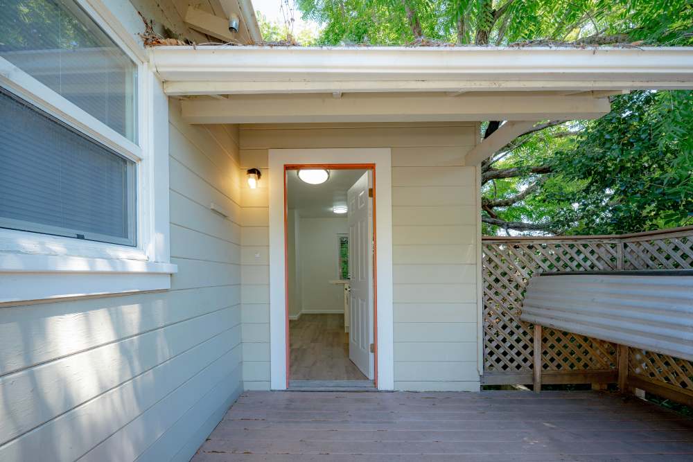 Welcoming entrance to a home featuring a well-lit doorway and exterior siding, leading to a cozy interior space, at Copa Cabanas in Santa Cruz, California.