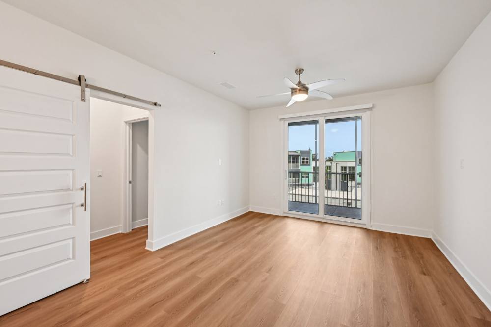 Empty Room with Ceiling Fan and Access to Patio at The Vivien in Vero Beach, Florida