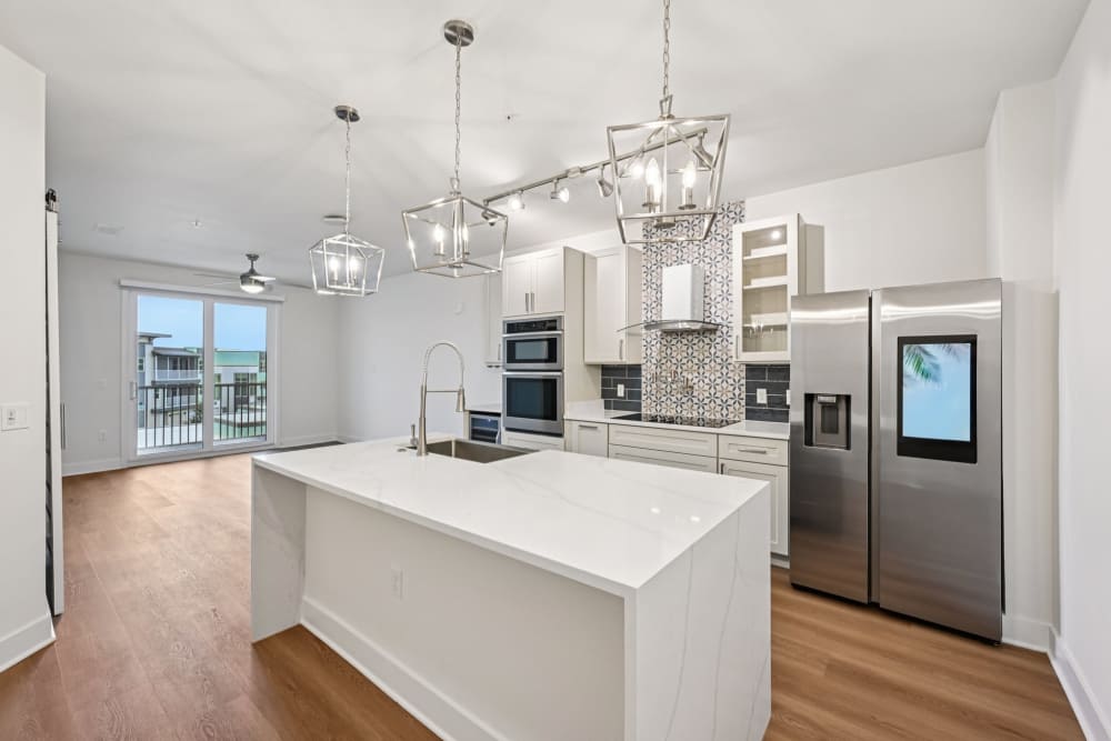 Kitchen with White Cabinets and Stainless-Steel Appliances at The Vivien in Vero Beach, Florida