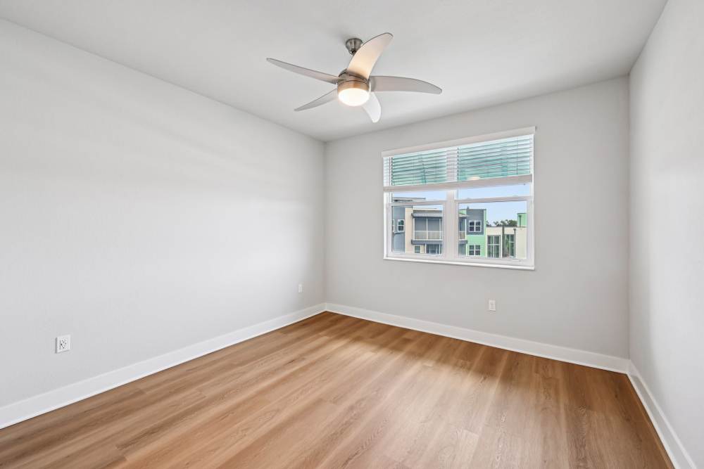 Empty Room with Ceiling Fan and Large Window at The Vivien in Vero Beach, Florida