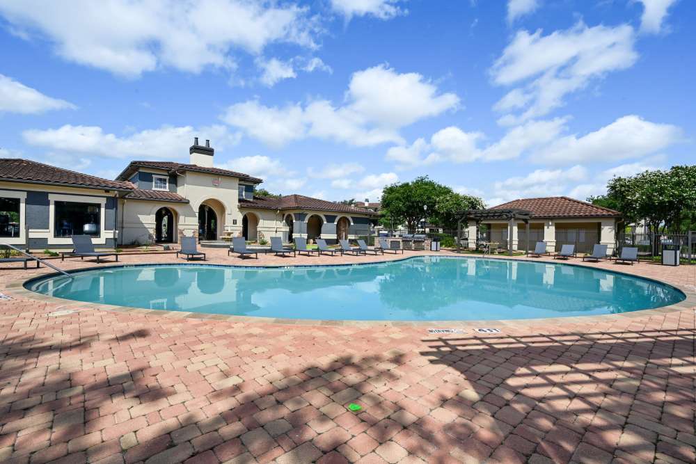 Resort-style community pool with lounge chairs at Vineyards in Katy,Texas
