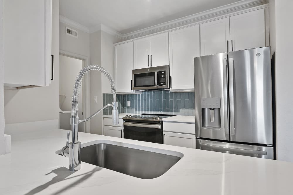 Kitchen with white cabinetry and stainless-steel refrigerator at Vineyards in Katy,Texas