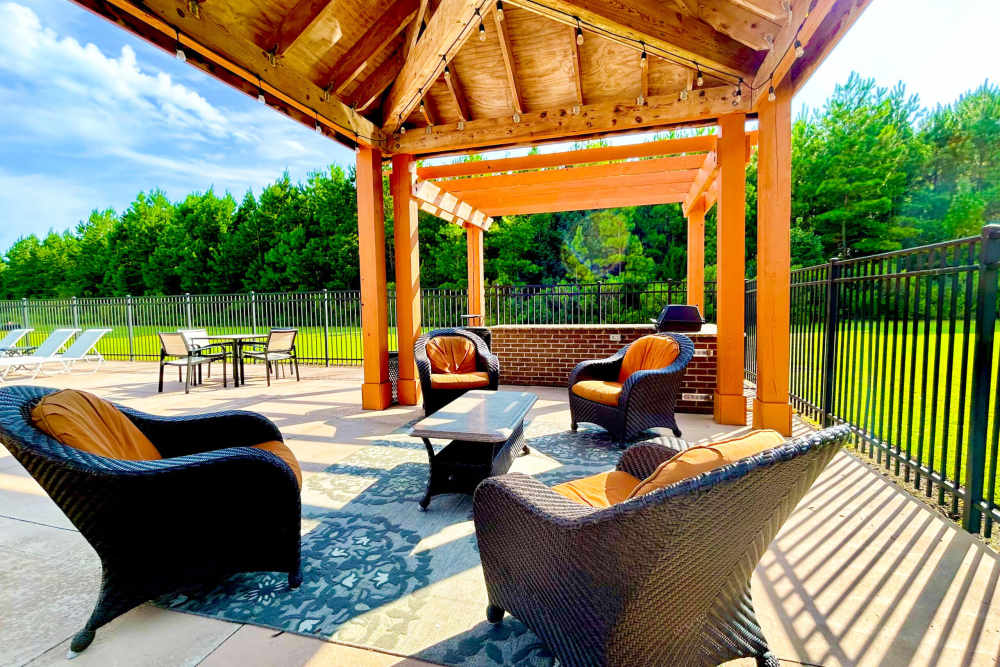 Covered outdoor lounge for residents at Arbors at Carolina Forest in Jacksonville, North Carolina