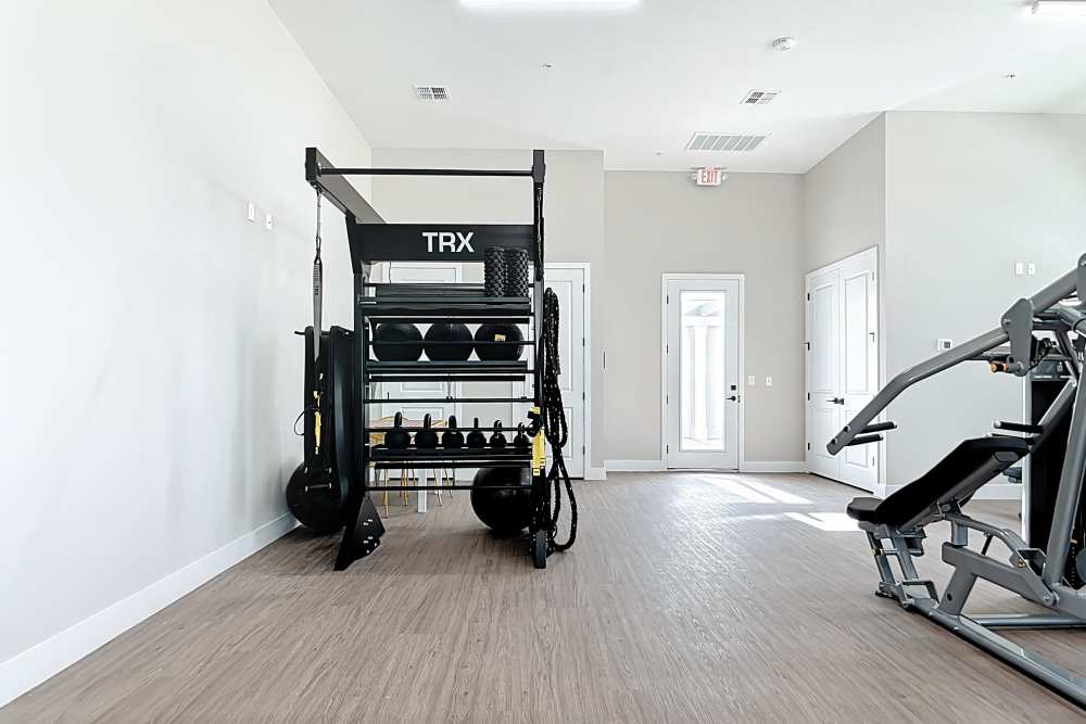 Fitness center with a rack for kettle balls and machines with at BB Living Wellen Park in Venice, Florida