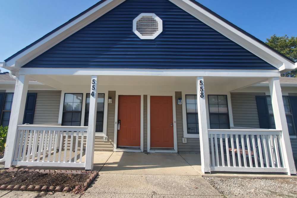 Exterior view of apartment with small plants and parking space at Oak Run Apartments in Columbus, Ohio