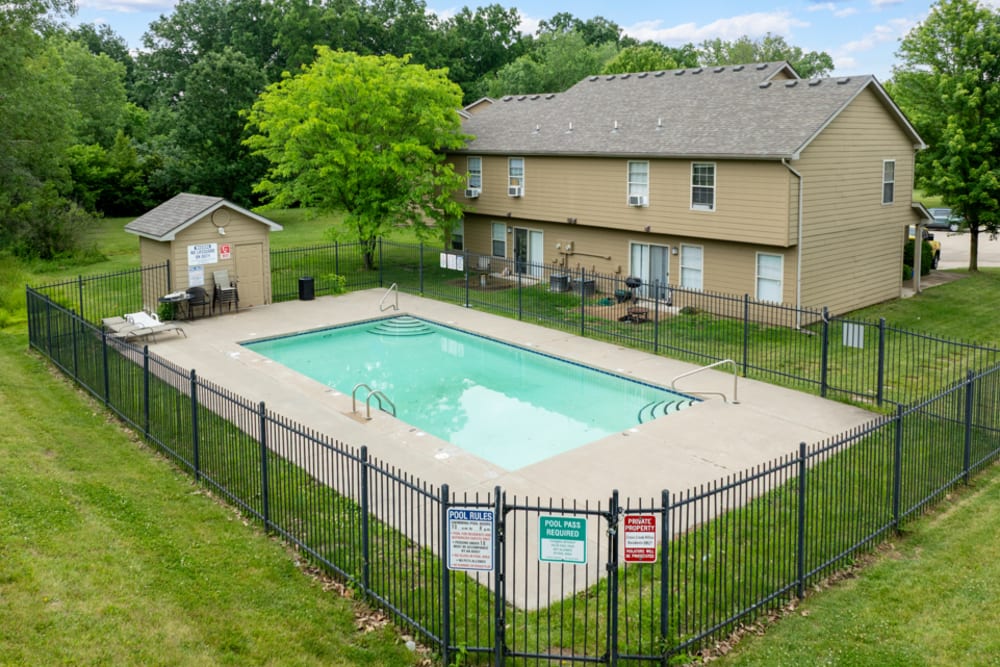 Beautiful exterior view of building surrounding with grassy walking paths and trees at Cross Creek Villas in Columbia, Missouri, 