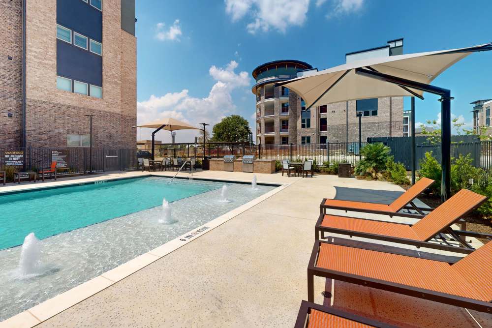 Gym at the park on the city's edge, featuring exercise equipment and green surroundings at The Heyward Apartments, Corinth, Texas.