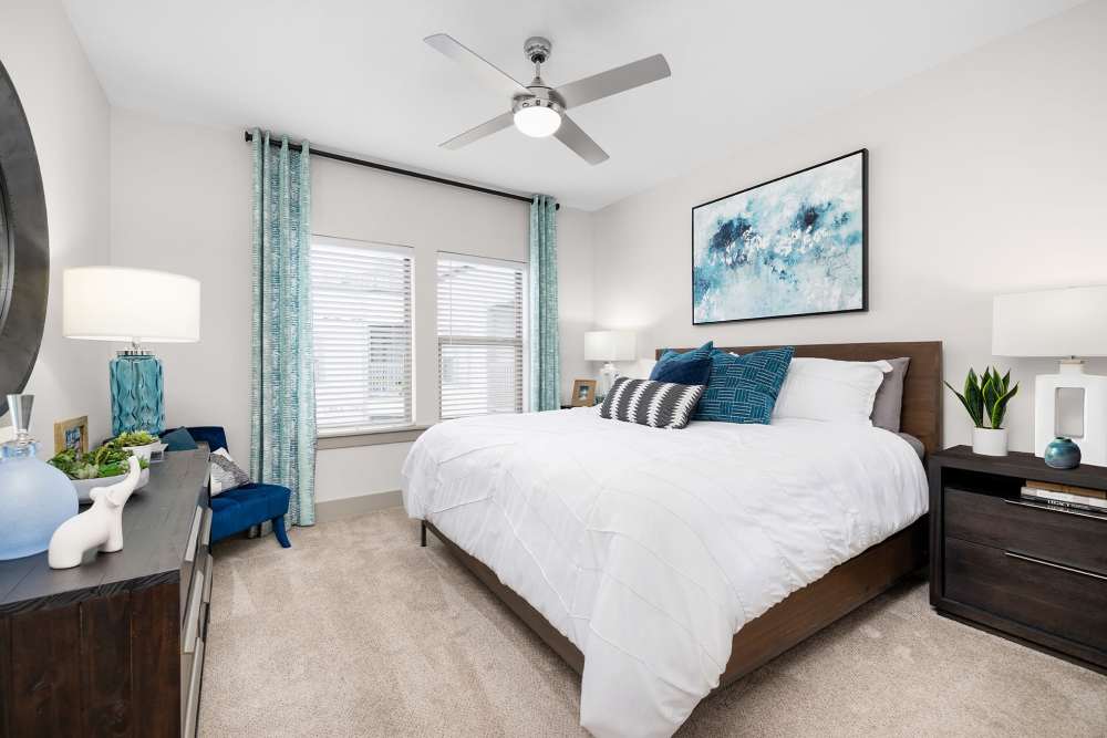 Furnished apartment bedroom with large window at SoBA Apartments in Jacksonville, Florida