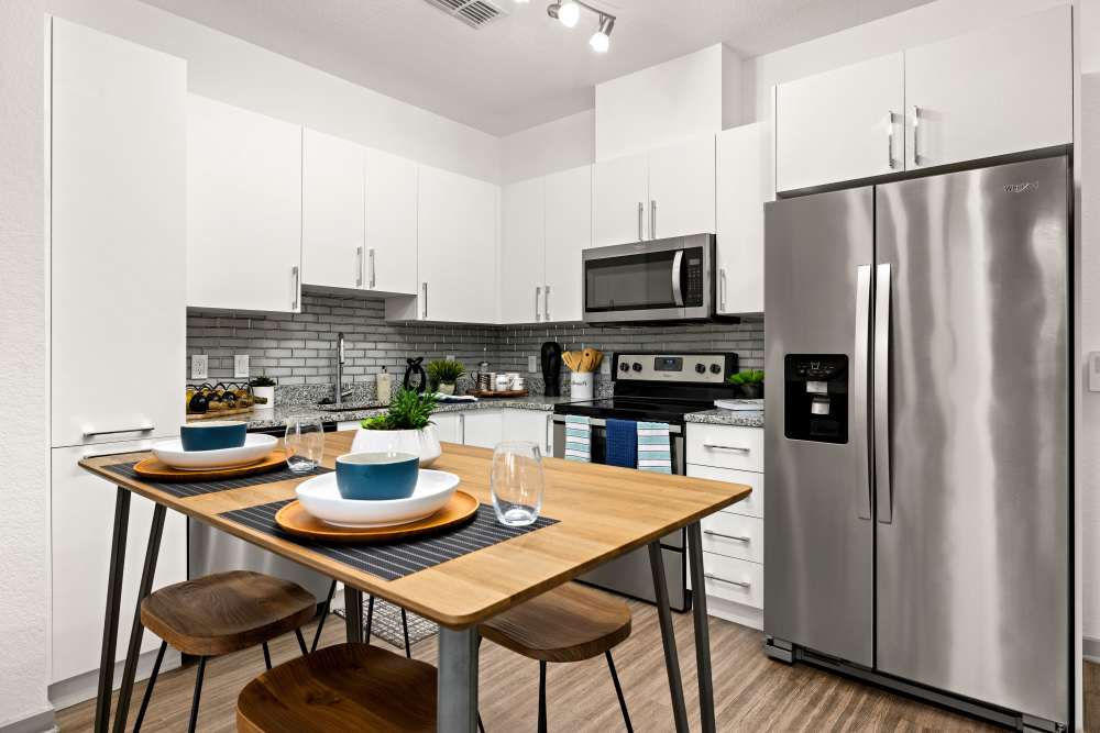 Eat-in kitchen with hardwood floors and all major appliances at Vue on Lake Monroe in Sanford, Florida