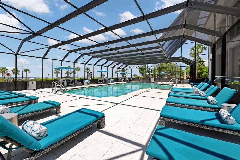 Indoor luxury pool with plenty of lounge chairs at Vue on Lake Monroe in Sanford, Florida