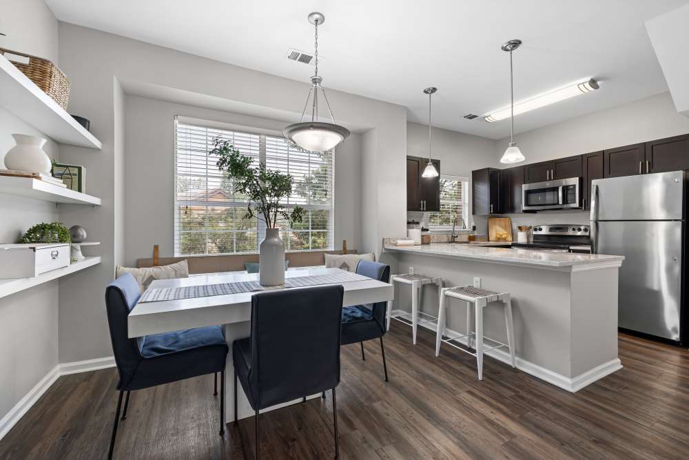 Model kitchen with bar seating at Isabella Apartment Homes in Greenwood Village, Colorado