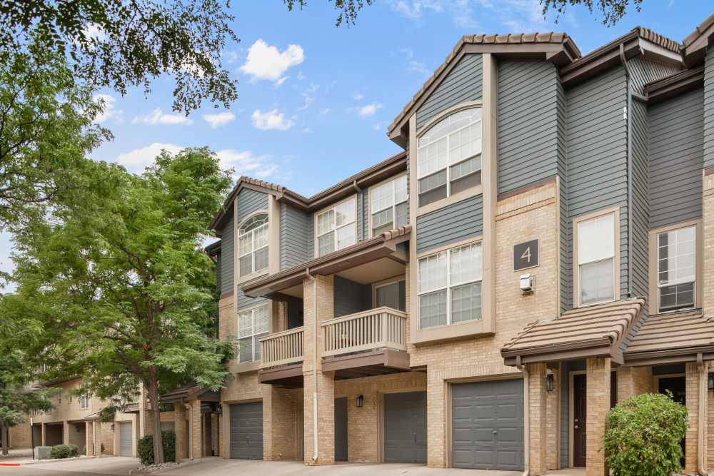 Bright exterior buildings with garages at Isabella Apartment Homes in Greenwood Village, Colorado