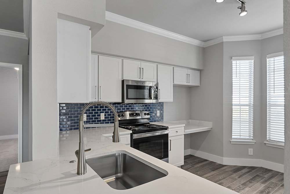 Kitchen with a white granite countertop and built-in microwave at Lyndon in Houston,Texas