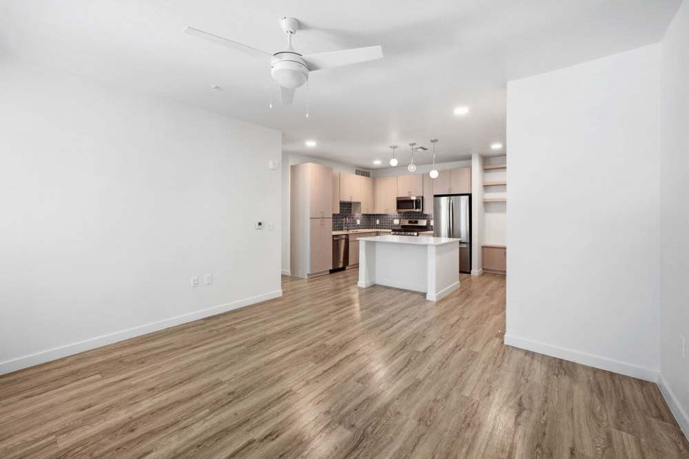 Living room with wood-style flooring at Lydian in Phoenix, Arizona