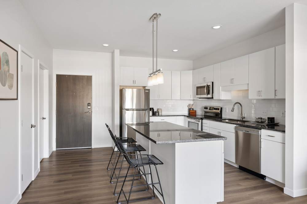 Modern kitchen with breakfast counter at Axle Apartments in Fridley, Minnesota