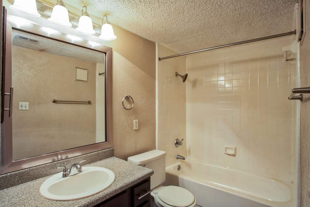 Bathroom with white vanity at Highlands Creek Apartments in Dallas,Texas