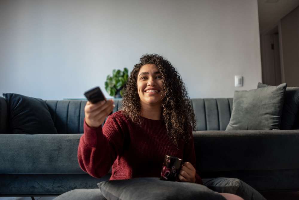 A resident woman operating a remote at Park Terrace Apartment Homes in Muskegon,Michigan