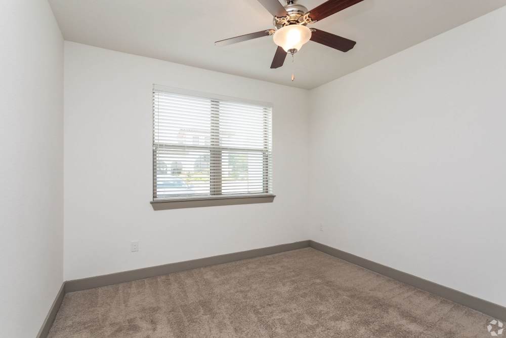 Cozy room with ceiling fan and natural light streaming in at Alcove at Alamo Heights in San Antonio, Texas