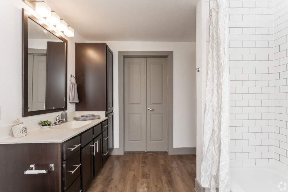 Modern bathroom with double vanity and stylish tile shower at Alcove at Alamo Heights in San Antonio, Texas