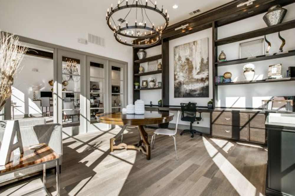 Stylish office with a round table and modern shelving units at Alcove at Alamo Heights in San Antonio, Texas