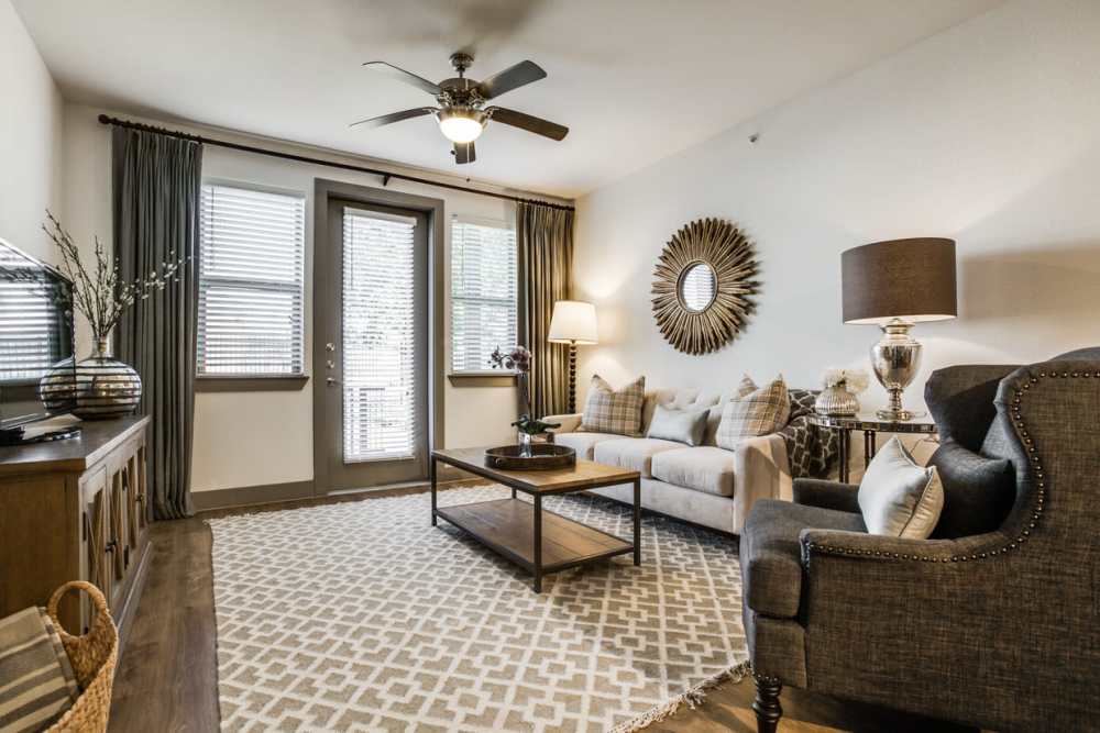 Sunlit living room with stylish decor and cozy seating at Alcove at Alamo Heights in San Antonio, Texas